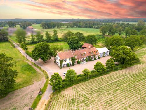an aerial view of a house in a field at De Blauwe Maaten in Neerglabbeek