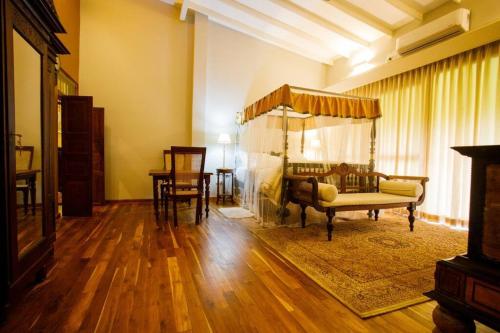a living room with a couch and a bed at Hailsham Bungalow in Sri Jayewardenepura Kotte