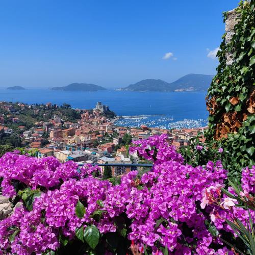 a view of a city with purple flowers at Miralunga la Villetta in Lerici