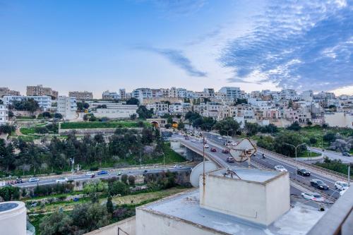a view of a city with traffic on a highway at Stylish & Cosy 1BR home with Balcony in St Julians BY 360 Estates in Tal-Għoqod