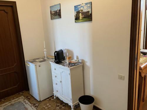 a room with a white cabinet with a microwave on it at Casamia in Senigallia