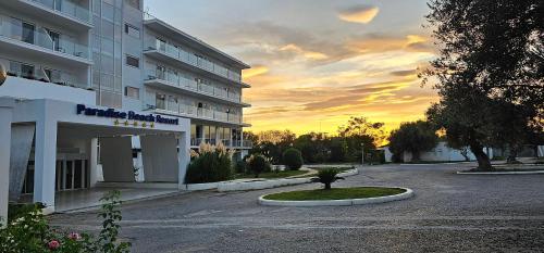 an empty parking lot in front of a building at O Paradise beach Resort and Spa in Magoúla