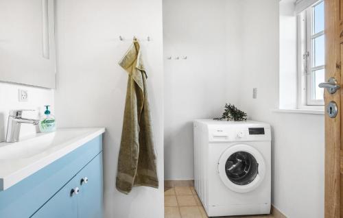 a white laundry room with a washing machine at Gorgeous Home In Karrebæksminde in Karrebæksminde