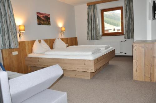 a bedroom with a bed and a window at Berghof in Berwang