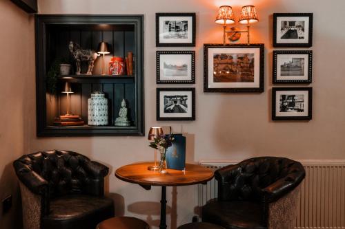 a room with two chairs and a table and a mirror at The Ashford Arms in Bakewell