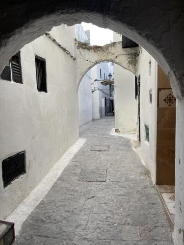an alley with an archway in an old building at Casa Marwan in Tetouan
