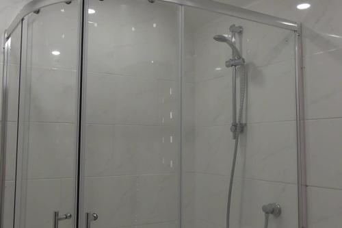 a shower with a glass door in a bathroom at 2 bedroom Holiday home in Norfolk private field in Wisbech