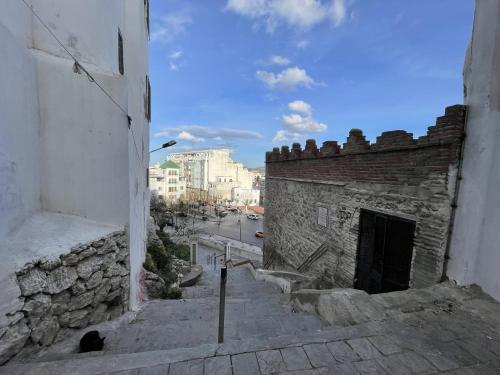 an old stone building with a door on a street at Casa Marwan in Tetouan