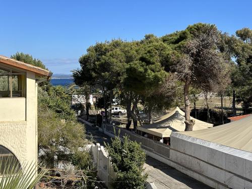 a view of a house with trees and a fence at Appartamento a 50 metri dal mare a Maladroxia C36 in Maladroxia