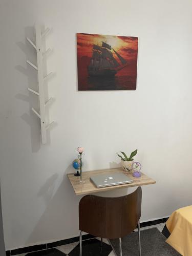 a desk with a laptop on top of a wall at Casa Marwan in Tetouan