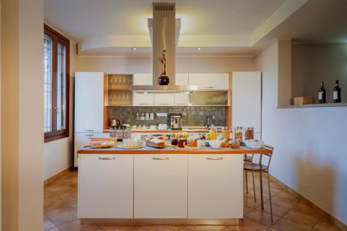 a kitchen with white cabinets and a counter top at Bergamo bnb in Villa di Serio