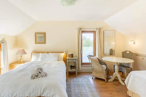 a bedroom with a bed with a towel on it at Kenmare Eco Lodge in Kenmare