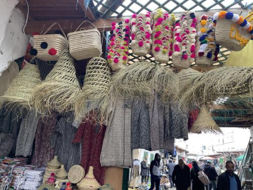 a market with a display of hats and baskets at Casa Marwan in Tetouan