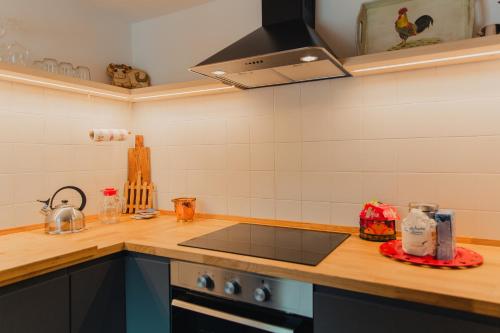 a kitchen with a counter top with a stove top oven at Alloggio in antica frazione Walser in Alagna Valsesia