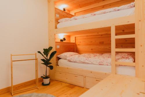 a bedroom with two bunk beds and a mirror at Alloggio in antica frazione Walser in Alagna Valsesia