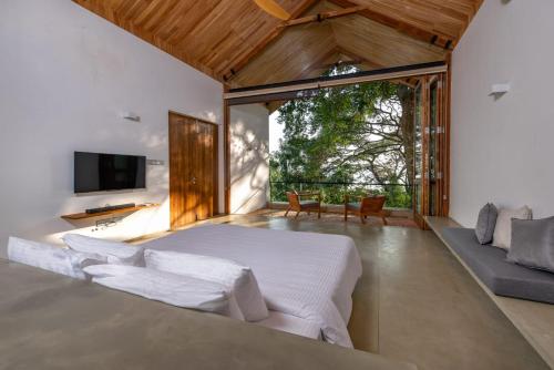 a bedroom with a large bed and a tv at Arachchi Heritage in Anuradhapura