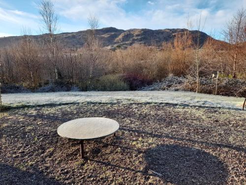 a table sitting in the middle of a field at Kenmare Eco Lodge in Kenmare