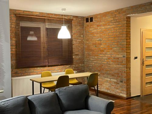 a living room with a couch and a table with chairs at The house by Trakt Lubelski in Warsaw in Warsaw