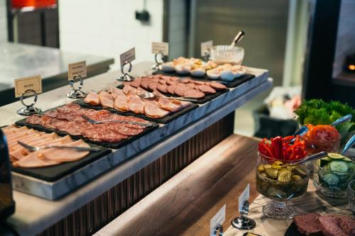 a buffet with meats and vegetables on a table at Ocean Hotel in Falkenberg