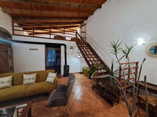 a living room with a couch and a staircase at Villa Nama in Kissamos