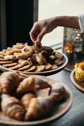 a person holding a teddy bear on a plate of bread at Ocean Hotel in Falkenberg