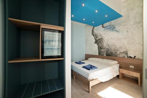 a bedroom with a bed and a blue wall at Mary Lucy in Porto Cesareo