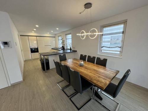 a kitchen and dining room with a wooden table and chairs at Kern Apartments in Rust