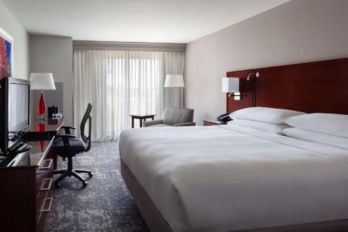 a hotel room with a large bed and a desk at DoubleTree by Hilton Minneapolis Airport, MN in Bloomington