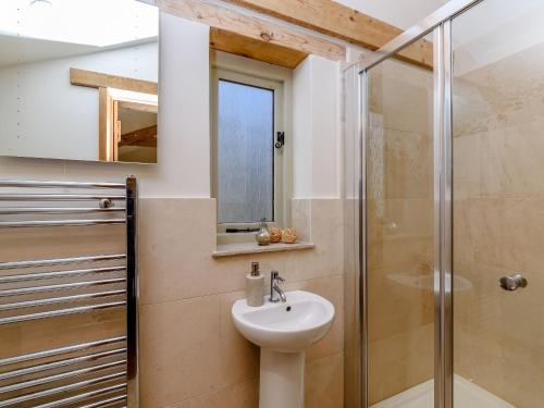 a bathroom with a sink and a shower at Budding in Dyrham