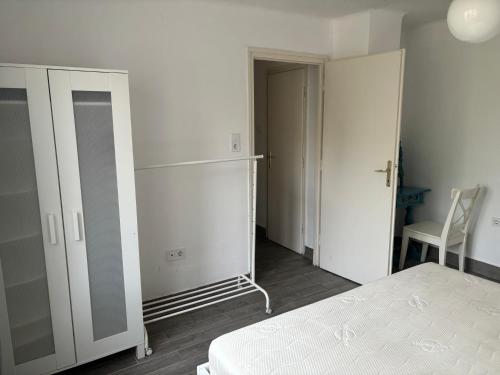 1 dormitorio con cama, armario y silla en Balatonszemes small House en Balatonszemes