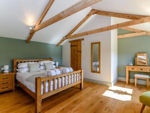 a bedroom with a bed in a room with wooden floors at Budding in Dyrham