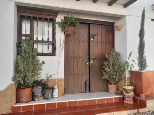 a front door of a house with potted plants at Iguaque Lodge in Villa de Leyva