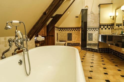 a large bathroom with a tub and a sink at Lainston House in Winchester