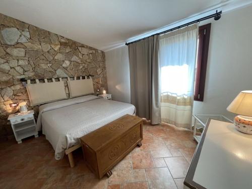 a bedroom with a bed and a stone wall at Casa Ada romantico appartamento in Chia