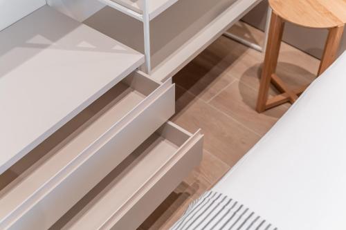 a stairwell with white drawers and a wooden stool at Casa Lambda in Jaca
