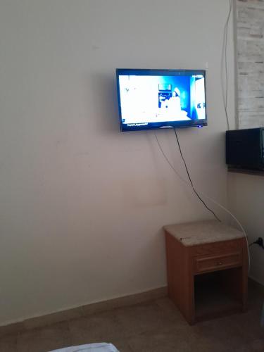a flat screen tv hanging on a white wall at Wesam property in Hurghada