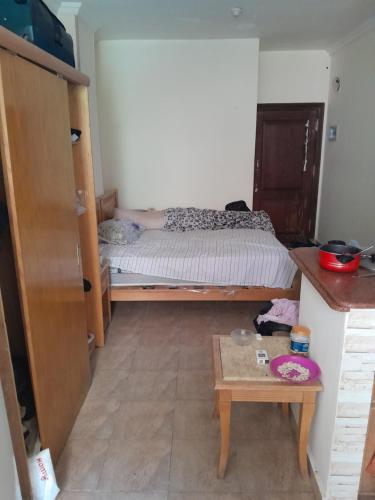 a small bedroom with a bed and a table at Wesam property in Hurghada