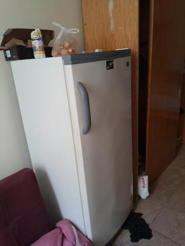 a white refrigerator with a black top in a room at Wesam property in Hurghada