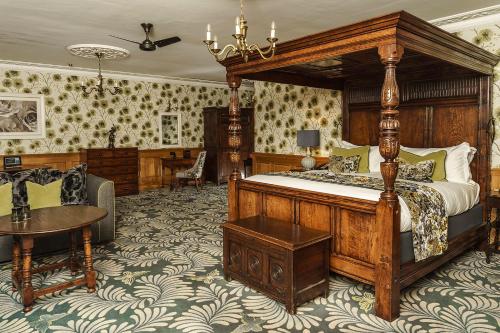 a bedroom with a large bed and a table at Lainston House in Winchester