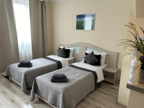 a hotel room with two beds with towels on them at H-Apartamenty Junior in Nowa Sól