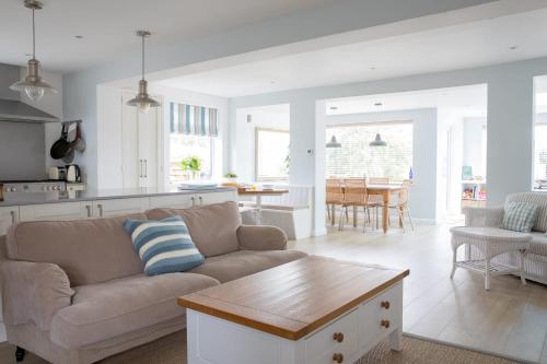 a living room with a couch and a table at Family Seaside Retreat - 5 minutes to Beach in West Wittering