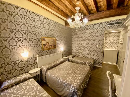 a bedroom with a bed and a couch in it at Hotel Bridge in Venice