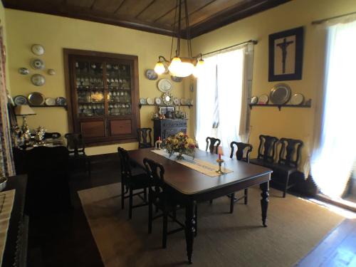 a dining room with a wooden table and chairs at Casa Da Ponte Arcos De Valdevez in Arcos de Valdevez