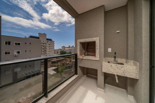 a balcony with a sink and a view of a city at Sunny Flats in Bombas