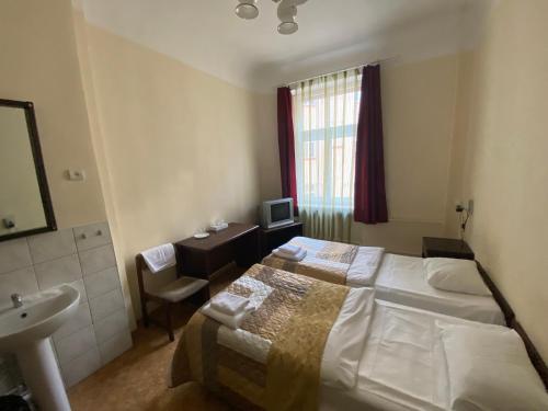 a bedroom with a bed and a sink and a mirror at Hostel Viktorija with Private Rooms in Rīga