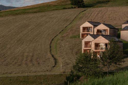 an aerial view of a house on a hill at Peterhof Chalets in Batschuns