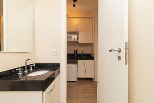 a kitchen with a sink and a counter top at Vossa Bossa VN Turiassu in Sao Paulo