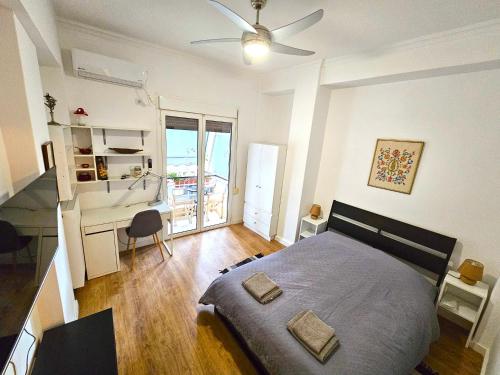 a bedroom with a bed and a desk and a table at Plato's Academy Home in Athens