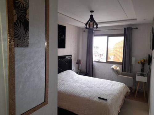 a bedroom with a white bed and a window at Welcome to Rabat Technopolis, Sala jadida, the book is open, We propose a private suite in a shared apartment, Dears A rab couples you may need a marriage certificate to rent the room According to Moroccan law, Thank you in advance in Oulad Yakoub