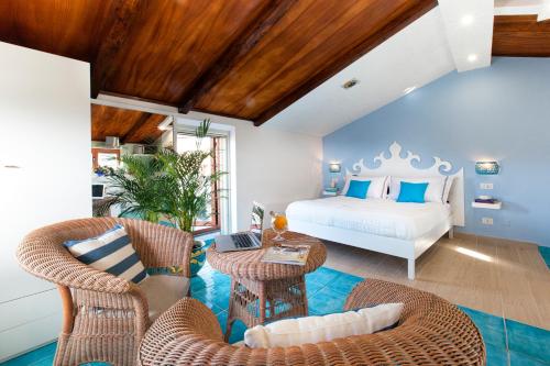 a bedroom with a bed and a table and chairs at Maison Villa Angela in SantʼAgata sui Due Golfi